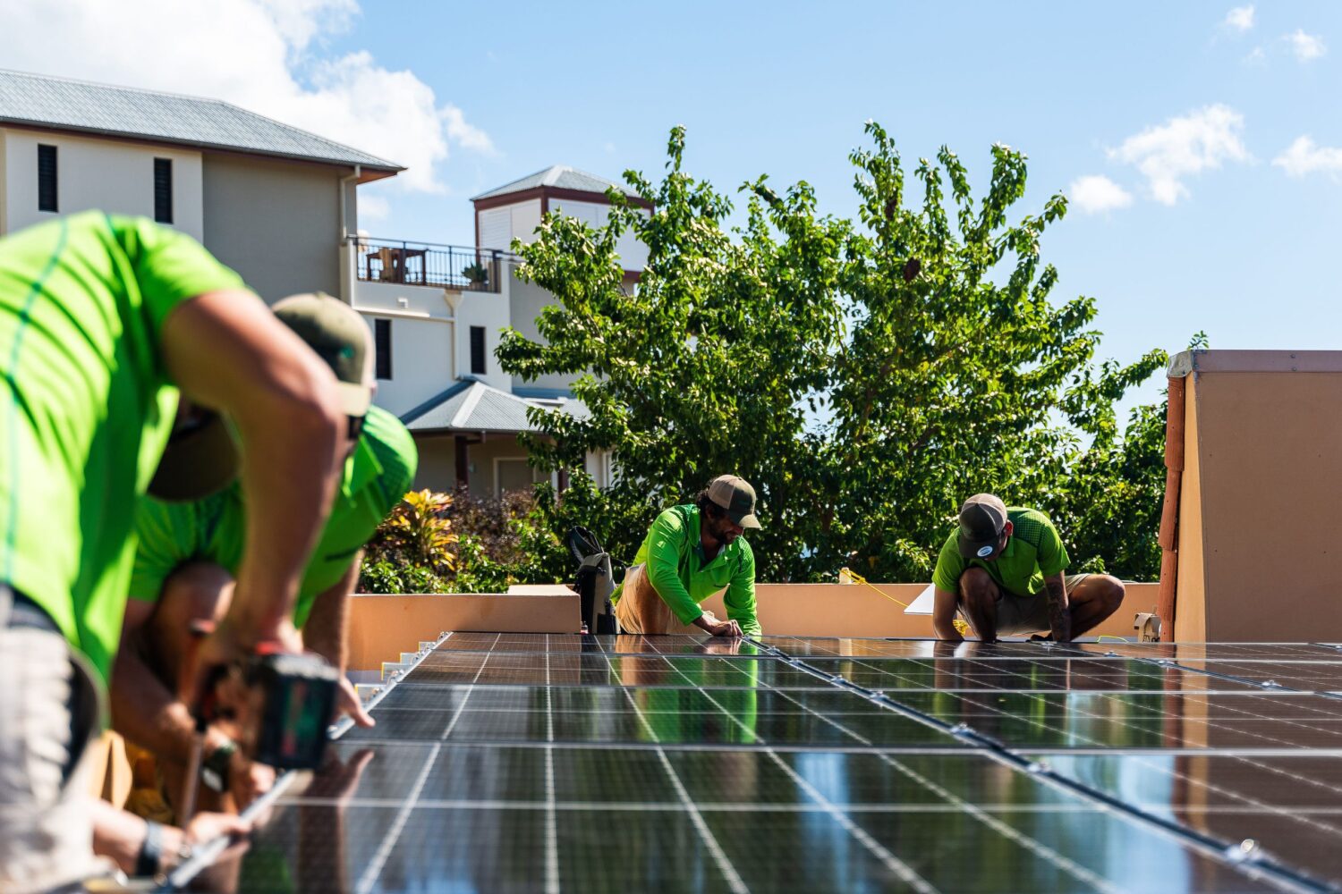 Solar installers securing solar panels on a rooftop under a sunny sky, ensuring efficient renewable energy installation Solar installers securing solar panels on a rooftop under a sunny sky, ensuring efficient renewable energy installation