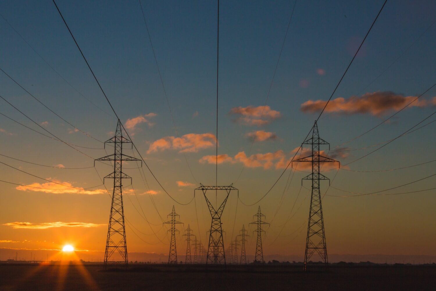 High Voltage Power Lines with Sunset Background