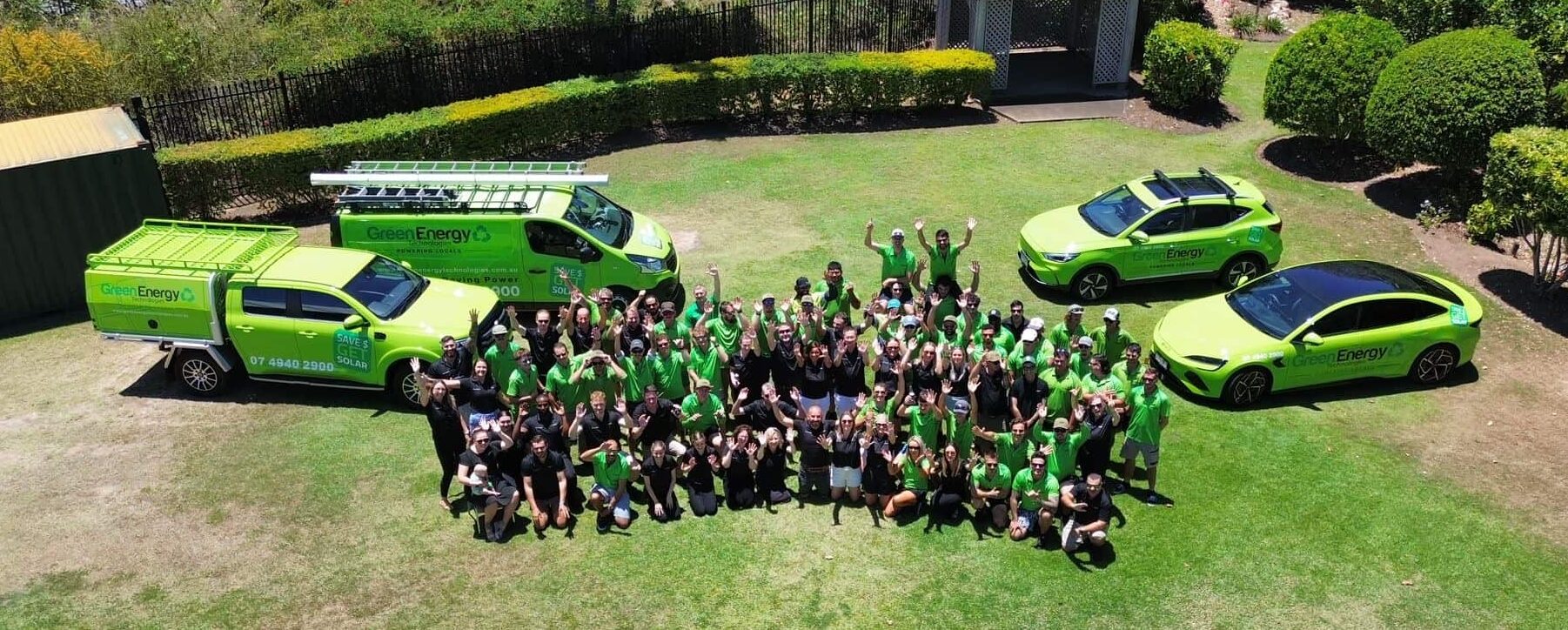 Green Energy Technologies solar panel installers team celebrating outdoors, showcasing their commitment to renewable energy solutions.
