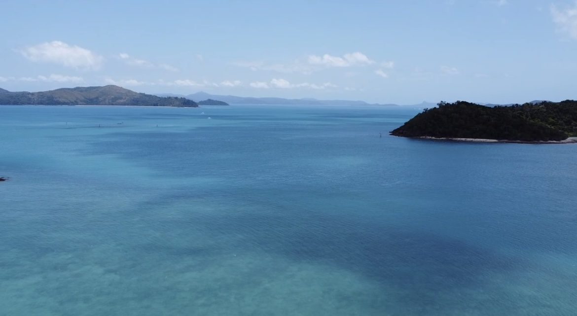 Blue sky over island and ocean